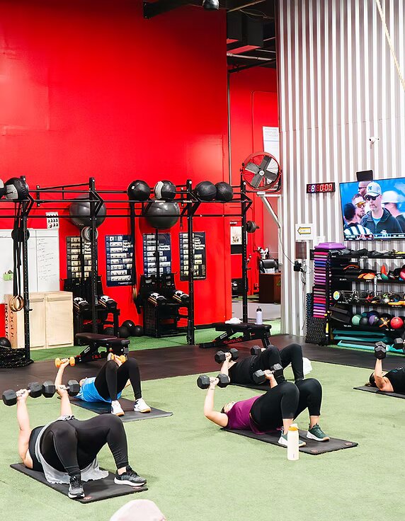 Members in a group training class at MaxFit